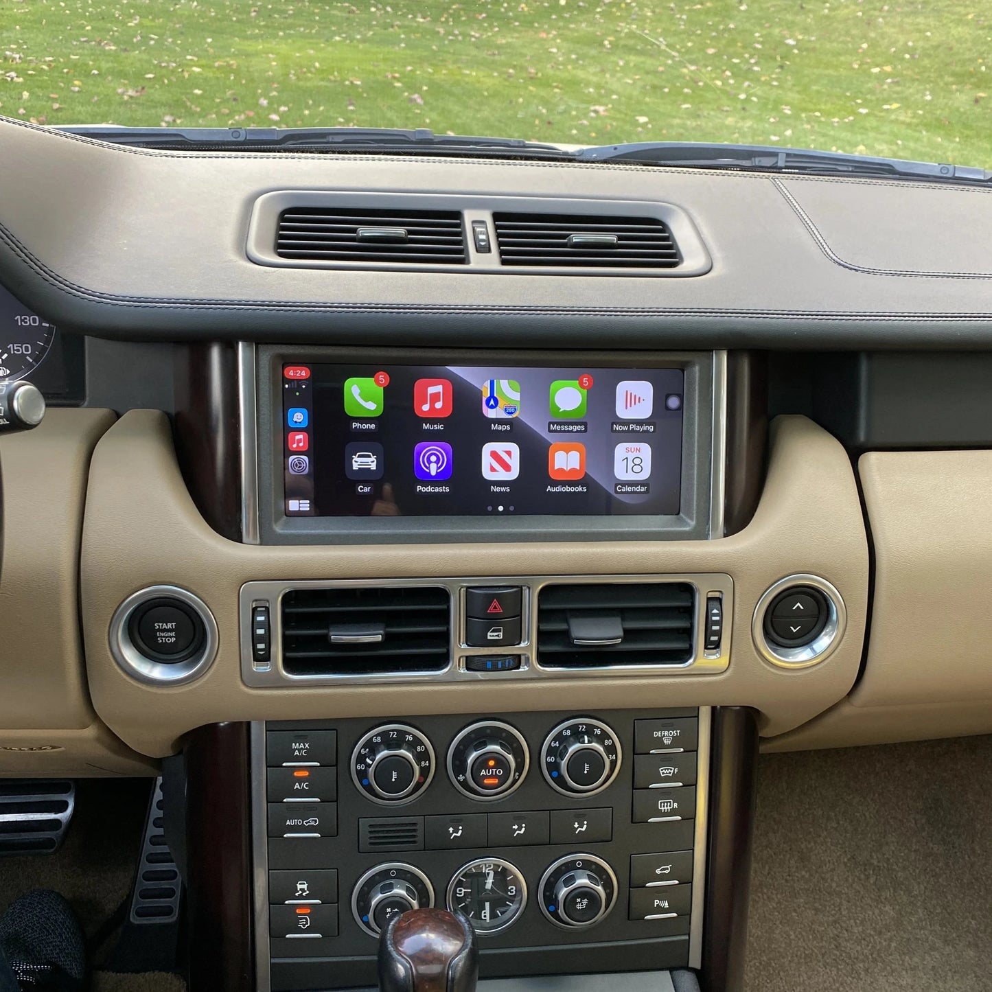 "Range Rover dashboard showing Apple CarPlay screen, promoting blog about CarPlay and product info"