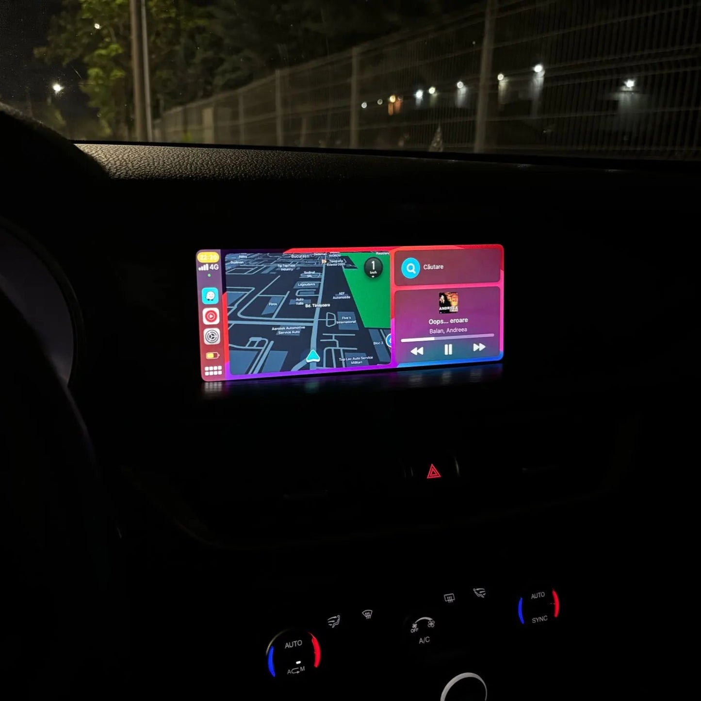Alfa Romeo infotainment screen displaying the integrated wireless Apple CarPlay apps interface at night.