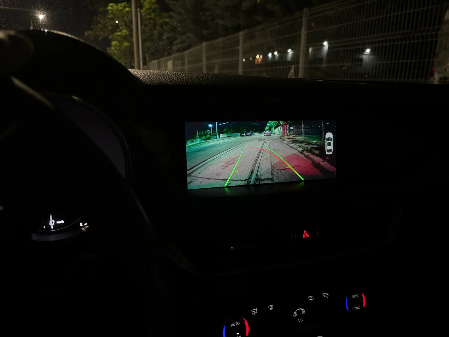 Alfa Romeo infotainment screen displaying the integrated wireless Apple CarPlay navigation at night.