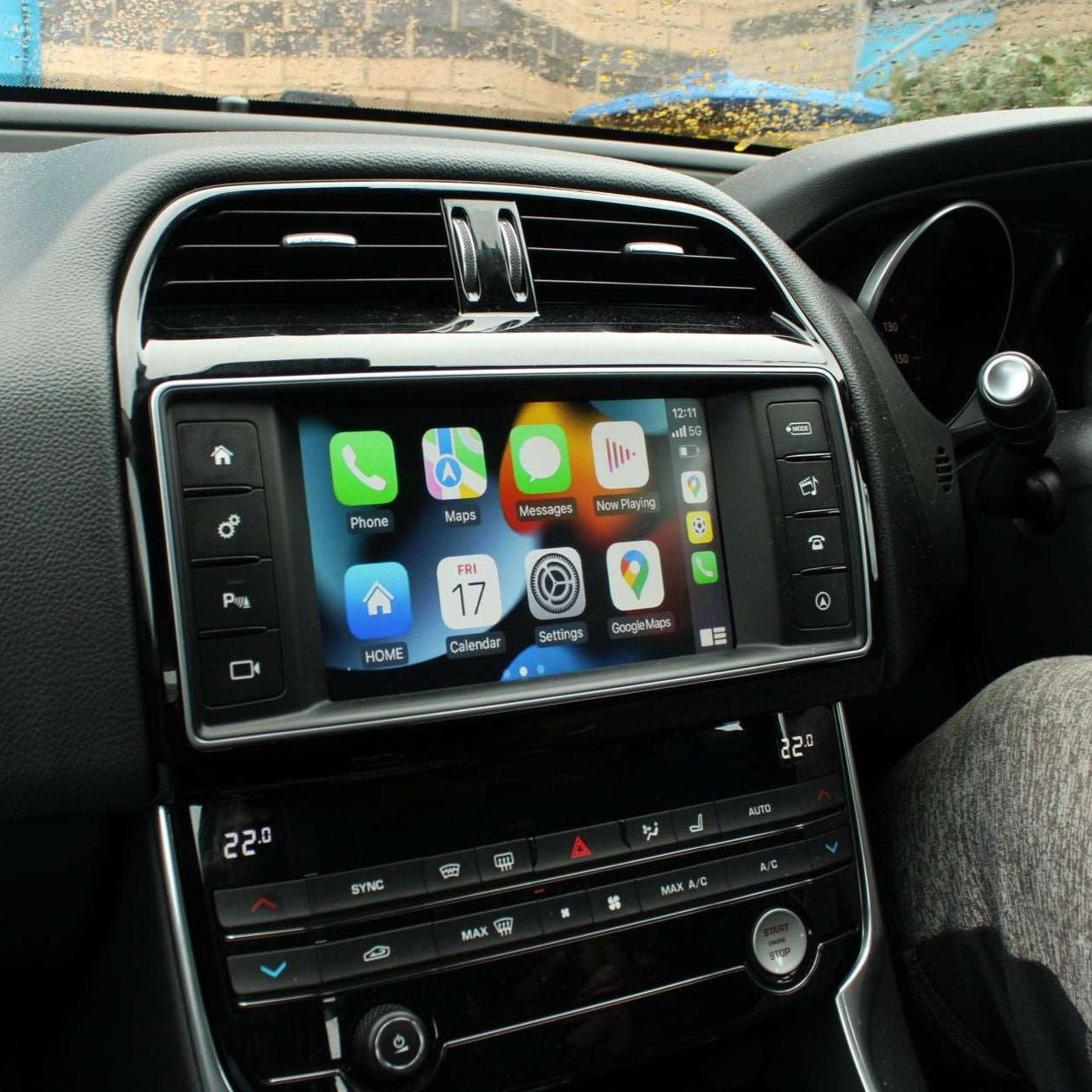 Jaguar interior showing the integrated wireless Apple CarPlay interface on the infotainment screen.