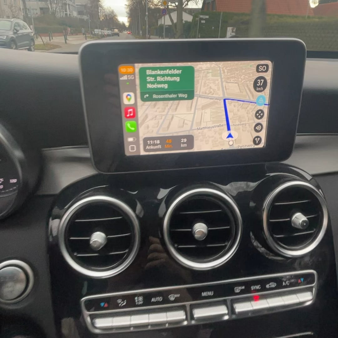 Mercedes-Benz C Class w205 interior dashboard showing the integrated wireless CarPlay system and control panel.