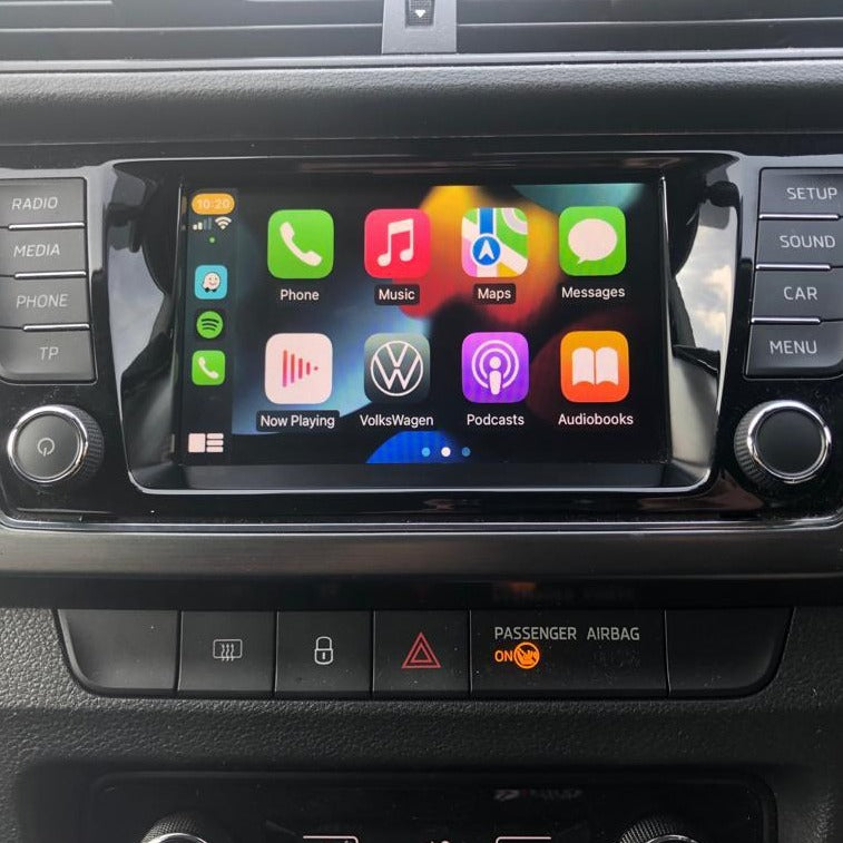 Skoda interior screen showing wireless Apple CarPlay apps with a standard background, integrated into the dashboard.