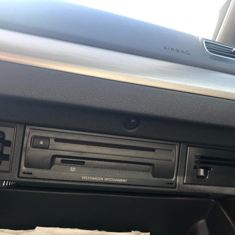 Close-up of a Volkswagen interior dashboard showing the USB port for the wireless CarPlay system.