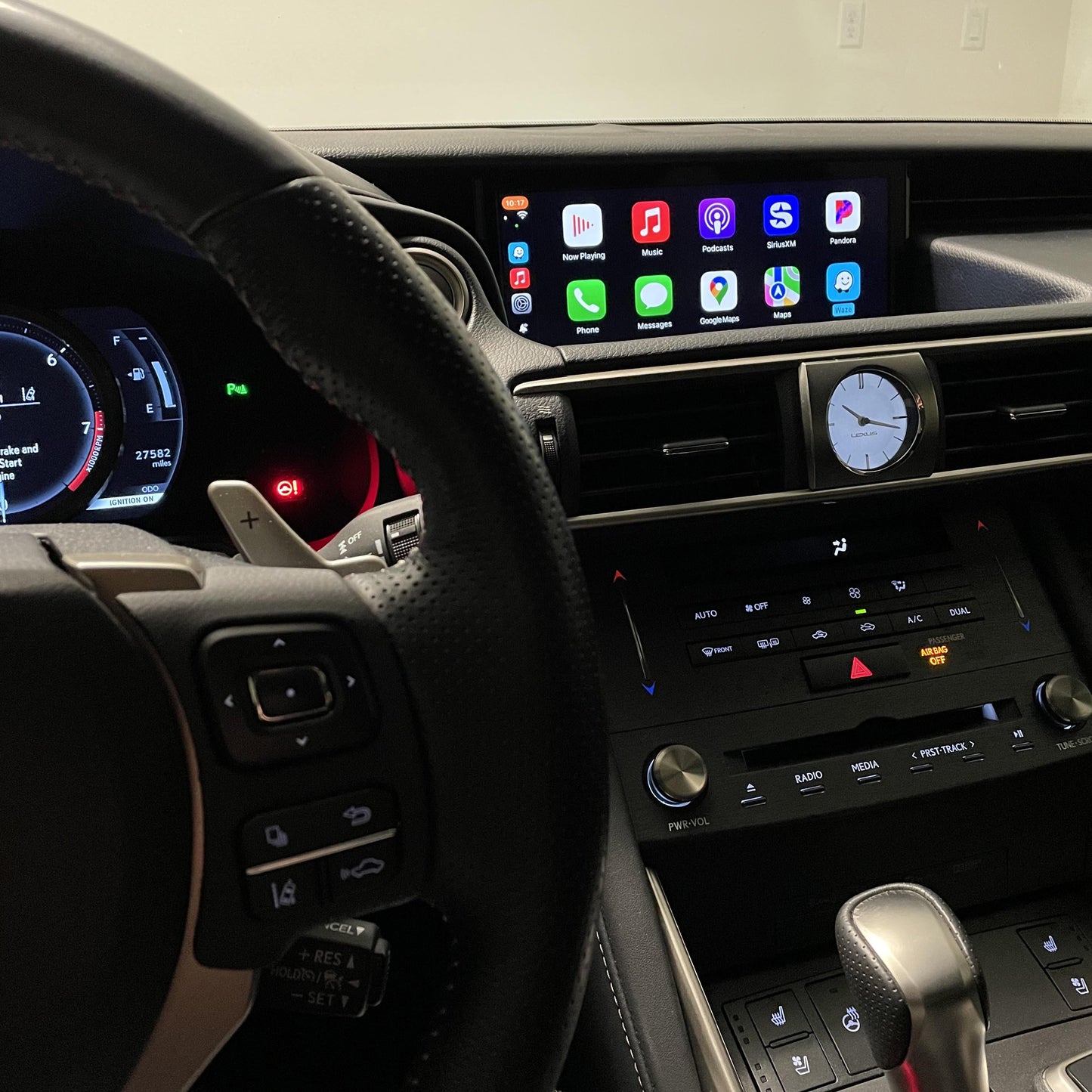 Lexus interior dashboard showing the integrated wireless Apple CarPlay interface on the infotainment screen.