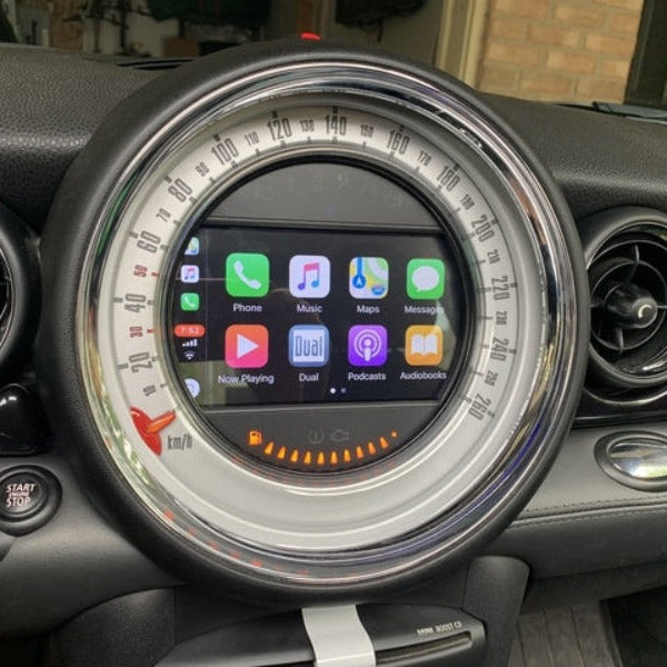 Classic-style MINI Cooper dashboard displaying the integrated wireless Apple CarPlay system.