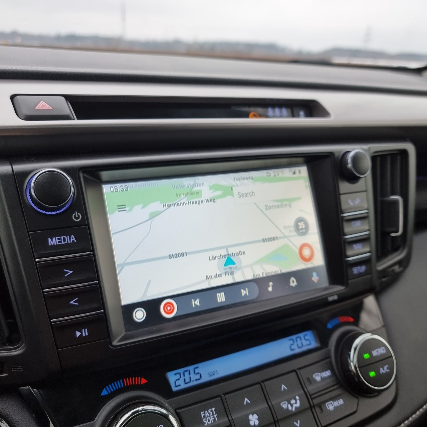 Toyota interior dashboard showing the integrated wireless Apple CarPlay interface on the infotainment screen.