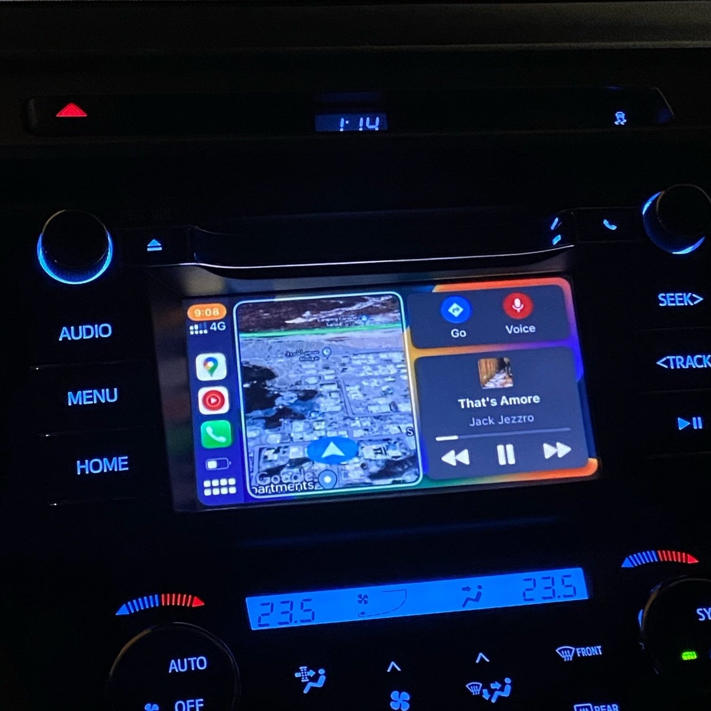 Toyota infotainment screen in a darker setting displaying the integrated wireless Apple CarPlay navigation.